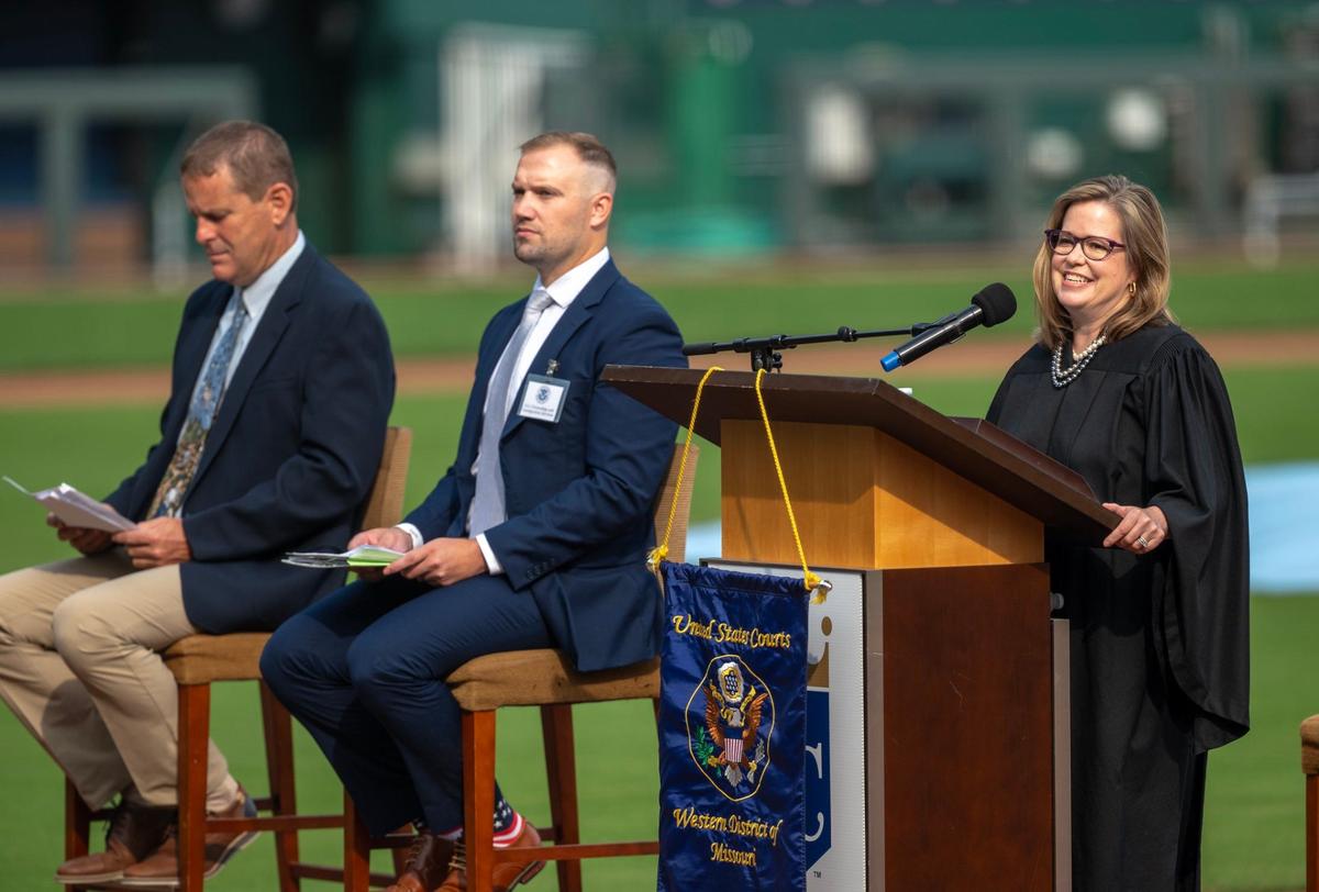 U.S. Magistrate Judge Jill A. Morris, right, speaks during a naturalization ceremony where more than 600 individuals from 95 countries became American citizens at Kauffman Stadium in Kansas City on Thursday, Sept. 12, 2024.