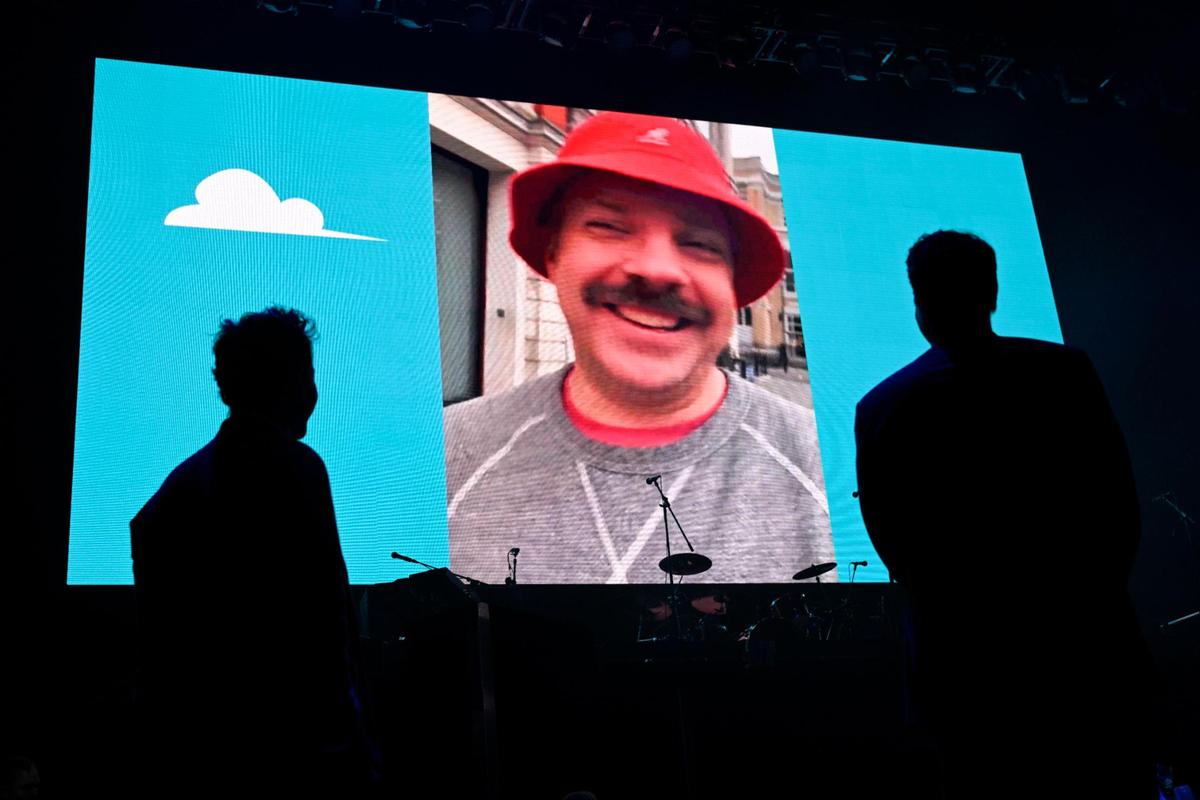 Jason Sudeikis couldn’t make it to Big Slick this year because he’s still filming his hit show, “Ted Lasso,” in London. But he made a video appearance at the Saturday night auction, as Paul Rudd, left, and Rob Riggle watched.