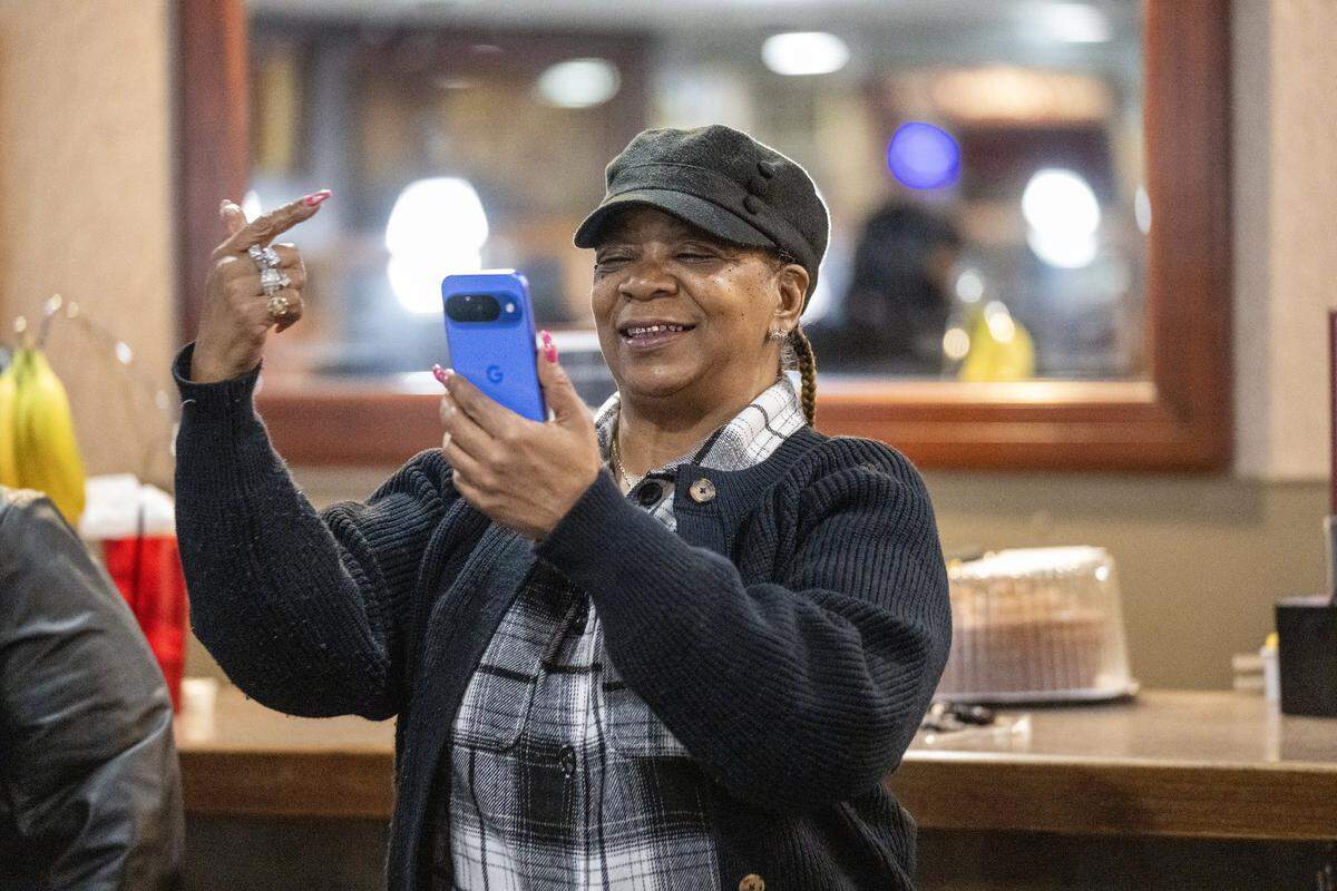 Kaye Murray of Kansas City records Denise “Ms. Niecie” Ward as she performs during “Dinner & A Show” on Friday, Feb. 6, 2026, at Niecie's Restaurant in Kansas City. Ward sings old school songs on the First Friday of every month at her soul food restaurant.