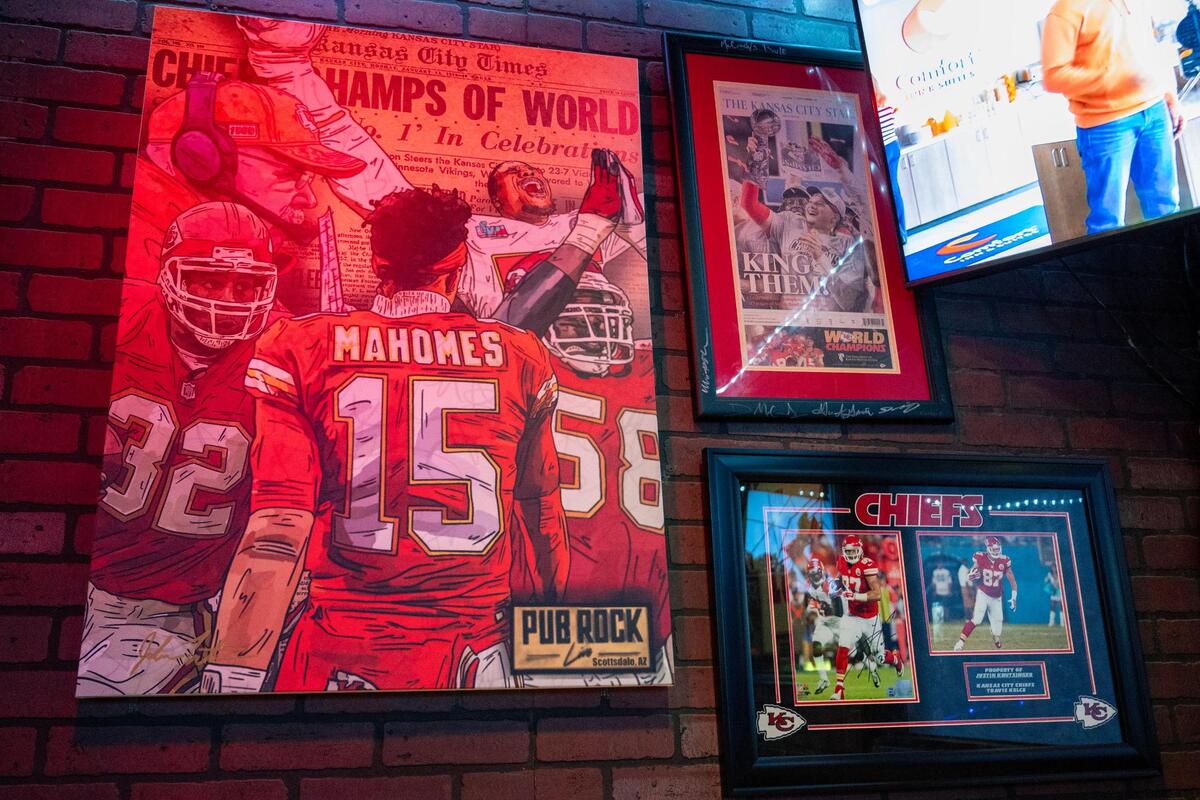Framed Kansas City Chiefs art, photos and news clippings are displayed on a wall at Pub Rock on Thursday, Feb. 8, 2024, in Scottsdale, Ariz.