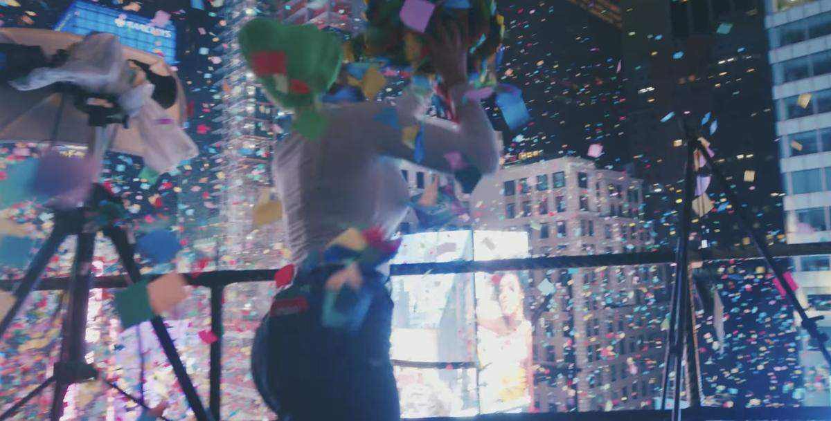 A volunteer throws a handful of confetti from a Times Square building on a recent New Year’s Eve.