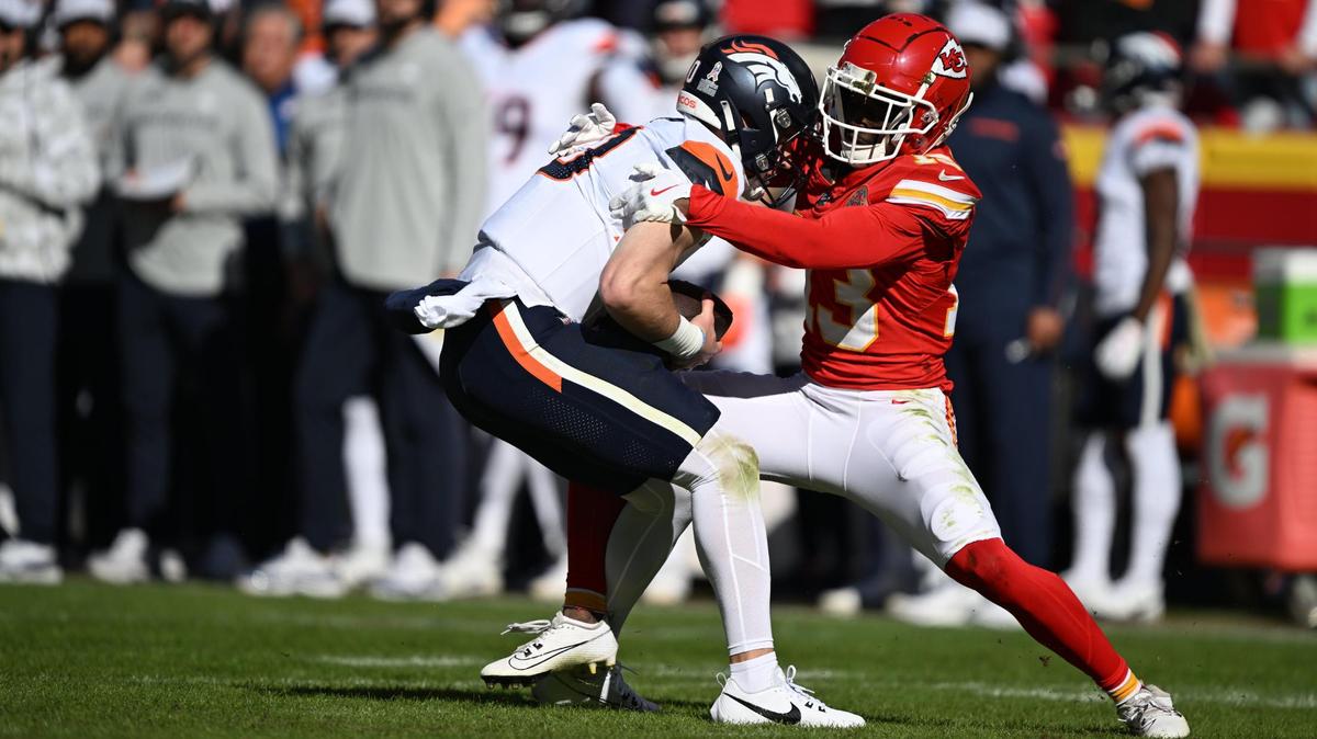 Kansas City Chiefs safety Nazeeh Johnson (13) sacks Denver Broncos quarterback Bo Nix (10) in the first half on Sunday, Nov. 10, 2024, at GEHA Field at Arrowhead Stadium.