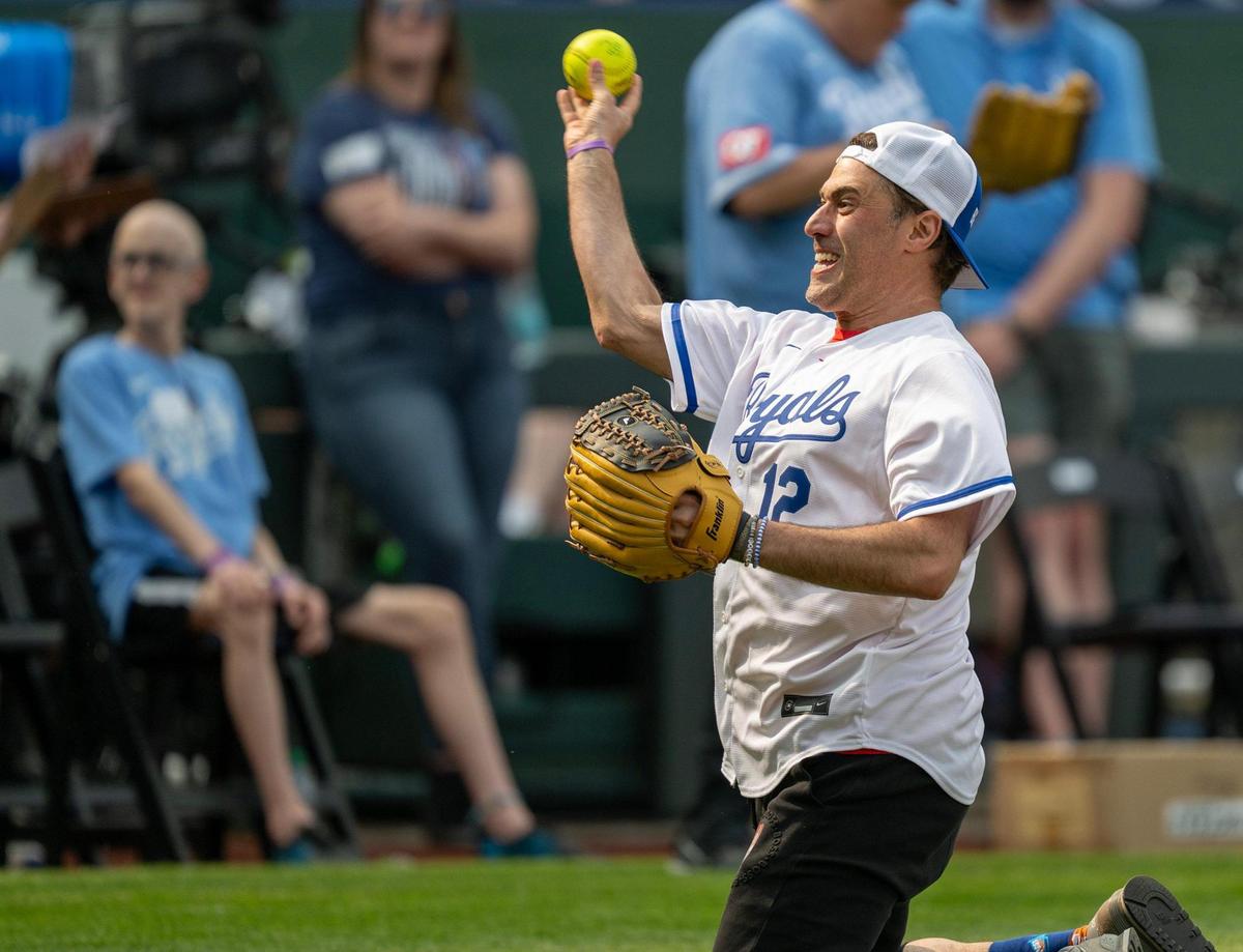 Adam Ray, comedian, throws from his knees at the Big Slick Celebrity Softball game on Friday, May 30, 2025, at Kauffman Stadium in Kansas City.