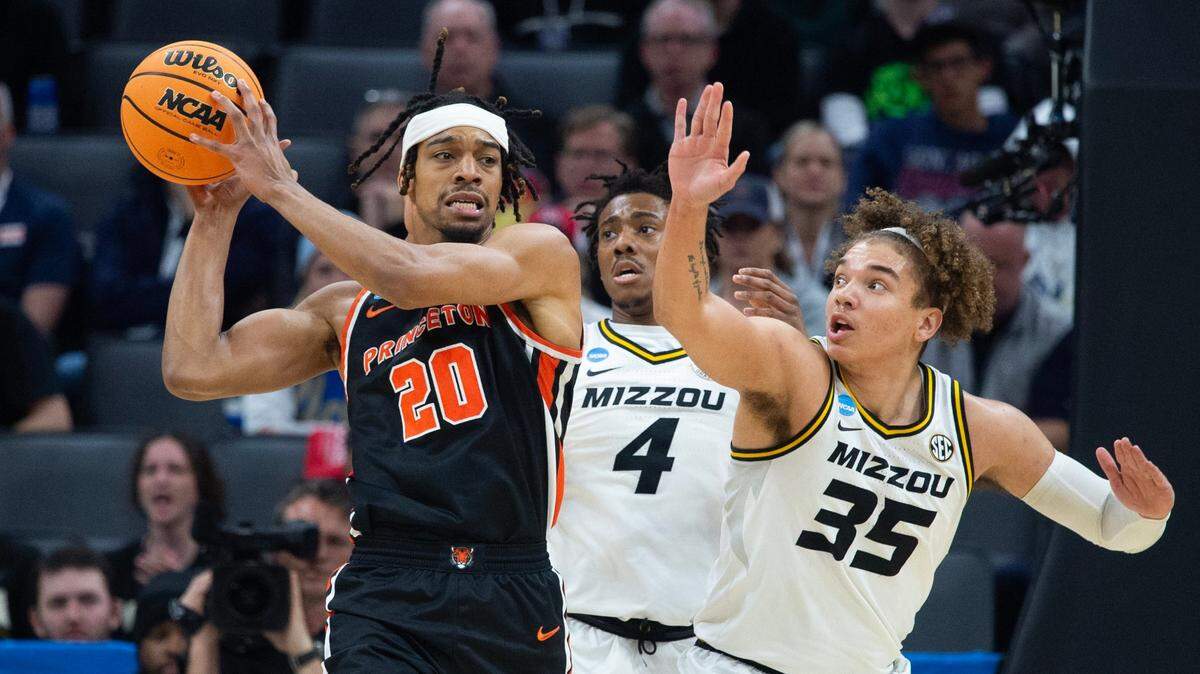 Princeton Tigers forward Tosan Evbuomwan (No. 20) looks to pass around the Missouri Tigers’ DeAndre Gholston (4) and Noah Carter (35) during Saturday’s NCAA Tournament South Region second-round game in Sacramento.