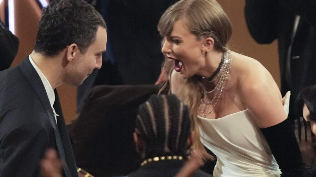 Taylor Swift, with record producer Jack Antonoff, was thrilled to win the Grammy for best pop vocal album, “Midnights,” in Los Angeles on Sunday. She announced a new album in her acceptance speech.