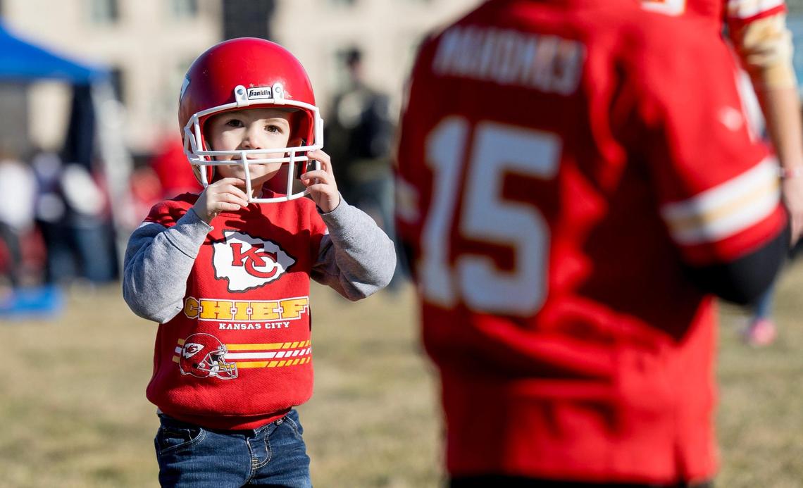 Odin Wilson, 4, adjusts his helmet while playing football with his brother Deacon, 7, before the Kansas City Chiefs Super Bowl LVIII victory parade on Wednesday, Feb. 14, 2024, in Kansas City.