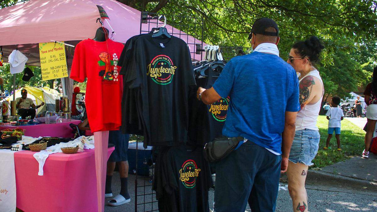 People look at Juneteenth T-Shirts at the annual Heritage Festival in Kansas City’s 18th and Vine District June 21, 2025.