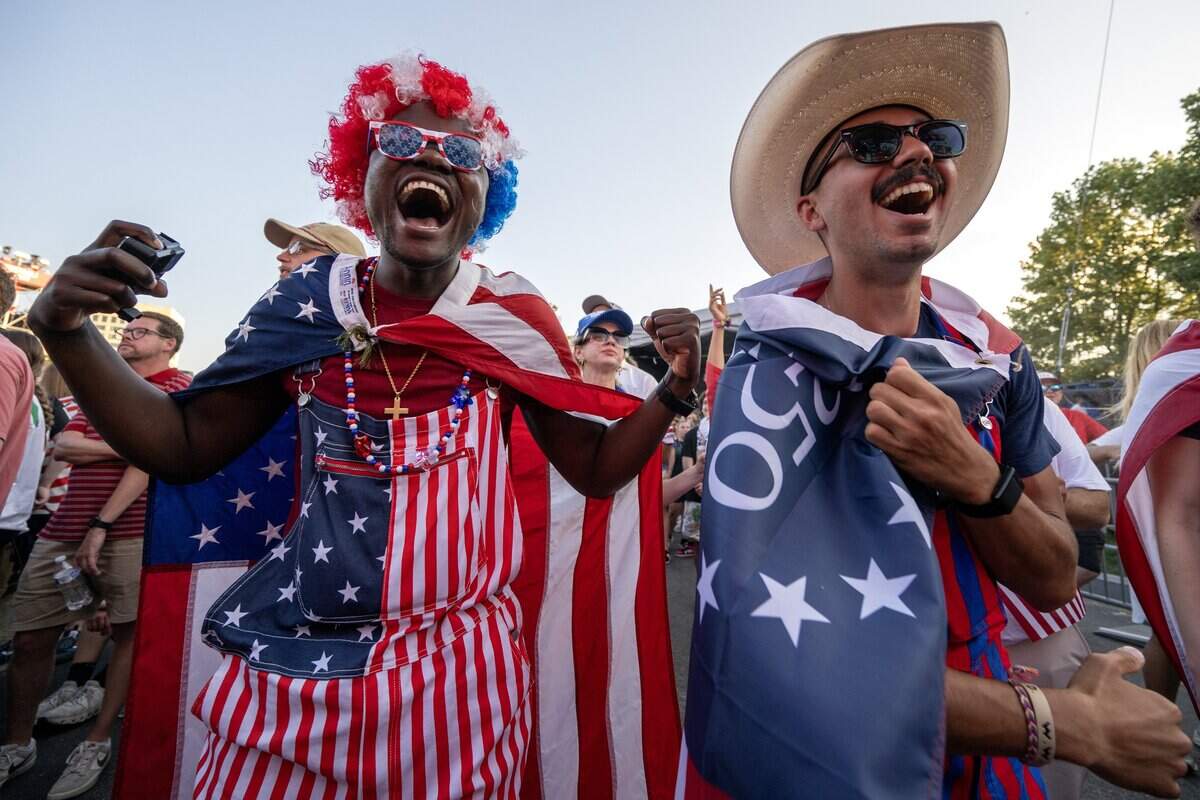 Jimmy Sandram, left, and Milo Navarro cheer while watching the Belgium-United States round of 16 match at the FIFA Fan Festival on Monday, July 6, 2026, in Kansas City.