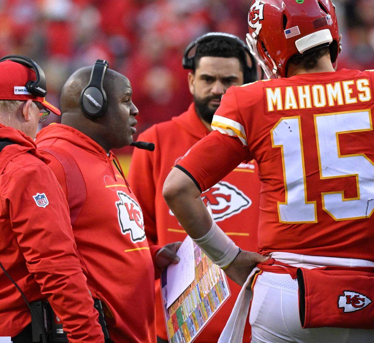 Kansas City Chiefs offensive coordinator Eric Bieniemy, second to left, confers with quarterback Patrick Mahomes during an AFC Championship Game timeout at Arrowhead Stadium on Jan. 30.