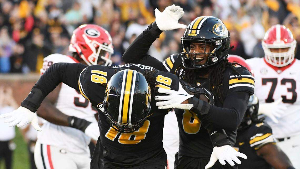 Missouri defensive lineman Trajan Jeffcoat, left, is congratulated by Tigers linebacker Ty’Ron Hopper after sacking Georgia quarterback Stetson Bennett Saturday night in Columbia.