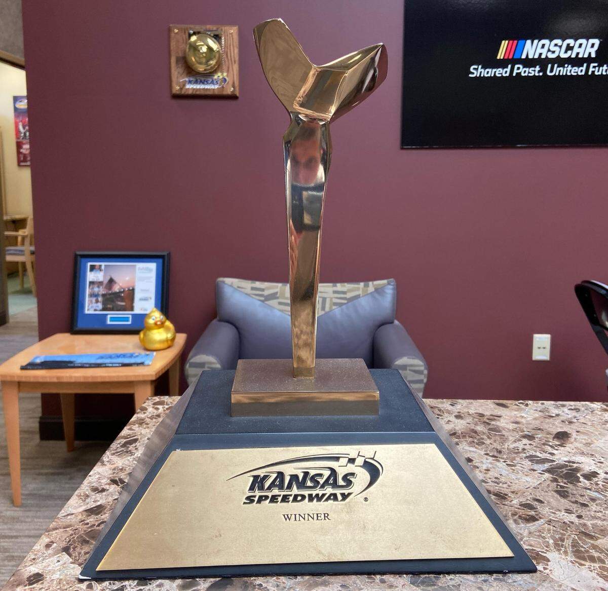 Former NASCAR driver Jeff Gordon, who won the first Cup race at Kansas Speedway in 2001, keeps the trophy he earned here that day on a mantle at his house. Called the “Soaring Trophy” and designed by the late May Marx, the top of the award is said to represent each turn at the Kansas Speedway track, and the tower the winning team’s hard work, endurance and inspiration in achieving their goal.