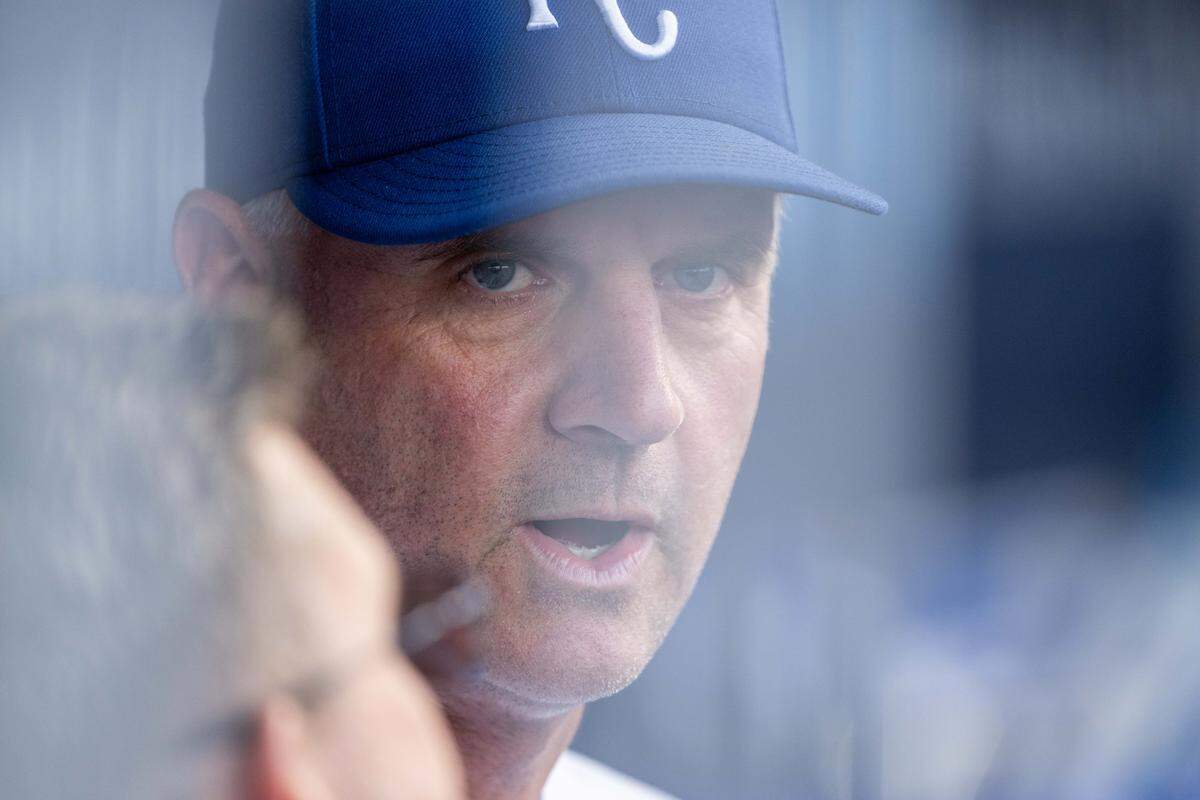 Kansas City Royals manager Matt Quatraro talks with an assistant during a game against the Boston Red Sox on Wednesday, May 20, 2026, at Kauffman Stadium.