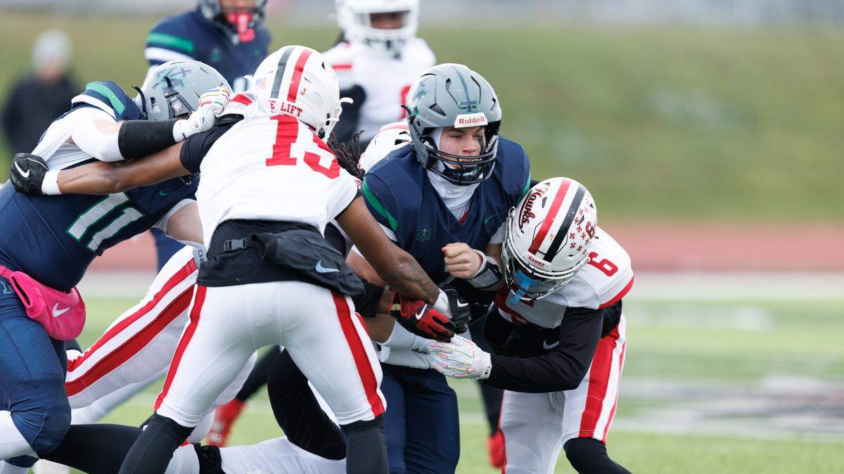 St. Michael the Archangel quarterback Gage Burgess fights for yardage during a 48-28 loss to Lift for Life in the Missouri Class 3 state high school football semifinals on Saturday, Nov. 29, 2025.