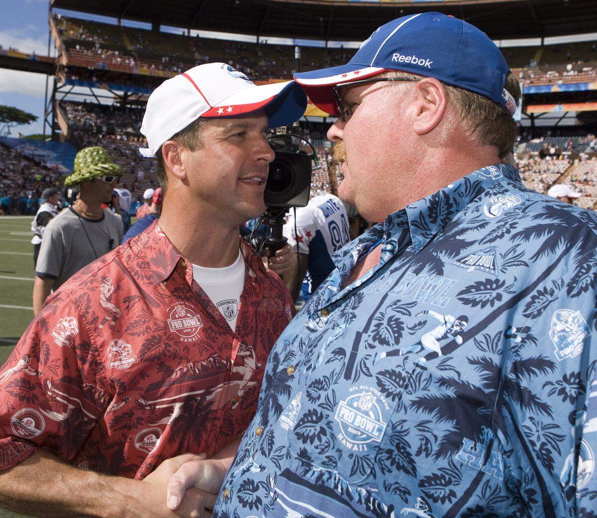 AFC coach John Harbaugh, left, of the Baltimore Ravens, congratulates NFC coach Andy Reid, of the Philadelphia Eagles, at the end of the Pro Bowl NFL football game at Aloha Stadium, Sunday, Feb. 8, 2009, in Honolulu. (AP Photo/Marco Garcia)