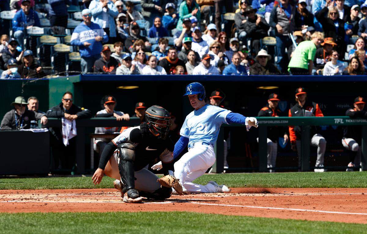 Royals left fielder Mark Canha slides safely into home plate, scoring a run against the Baltimore Orioles in a Major League Baseball game at Kauffman Stadium in Kansas City on Sunday, April 6, 2025.