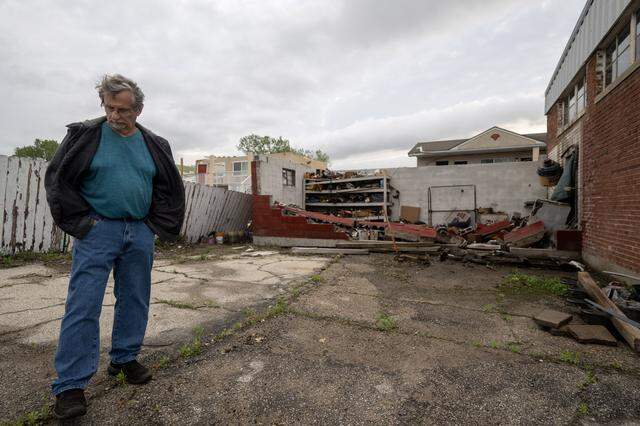 Randy McCurdy, owner of McCurdy’s Auto Sales & Auto Service, looked over damage on Tuesday, April 14, 2026, in Ottawa, Kansas, after a tornado moved through the town Monday night.