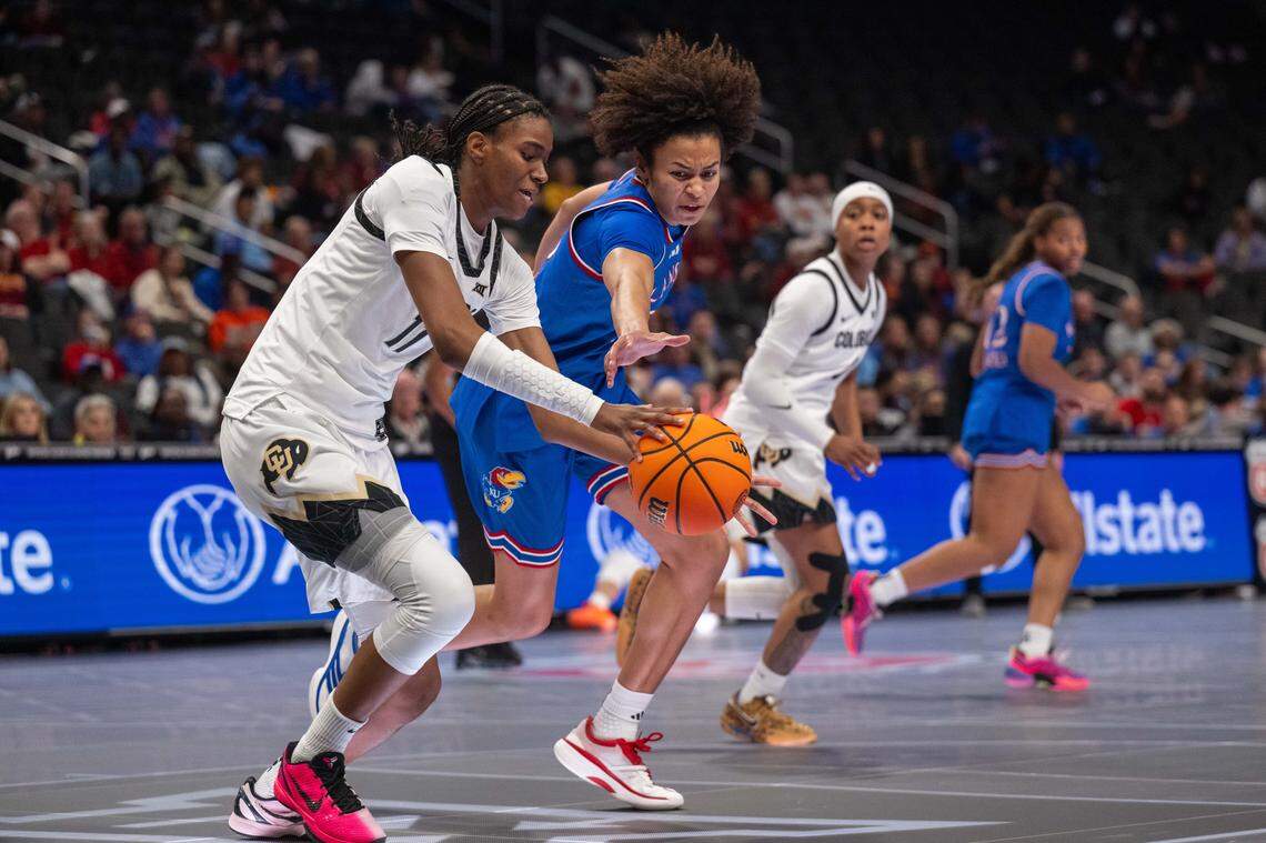 Kansas Jayhawks forward Jaliya Davis (25) fights for a loose ball against Colorado Buffaloes forward Jade Masogayo (14) in the first half of KU’s second-round game at the Big 12 Women's Basketball Tournament on Thursday, March 5, 2026, at T-Mobile Center in Kansas City.