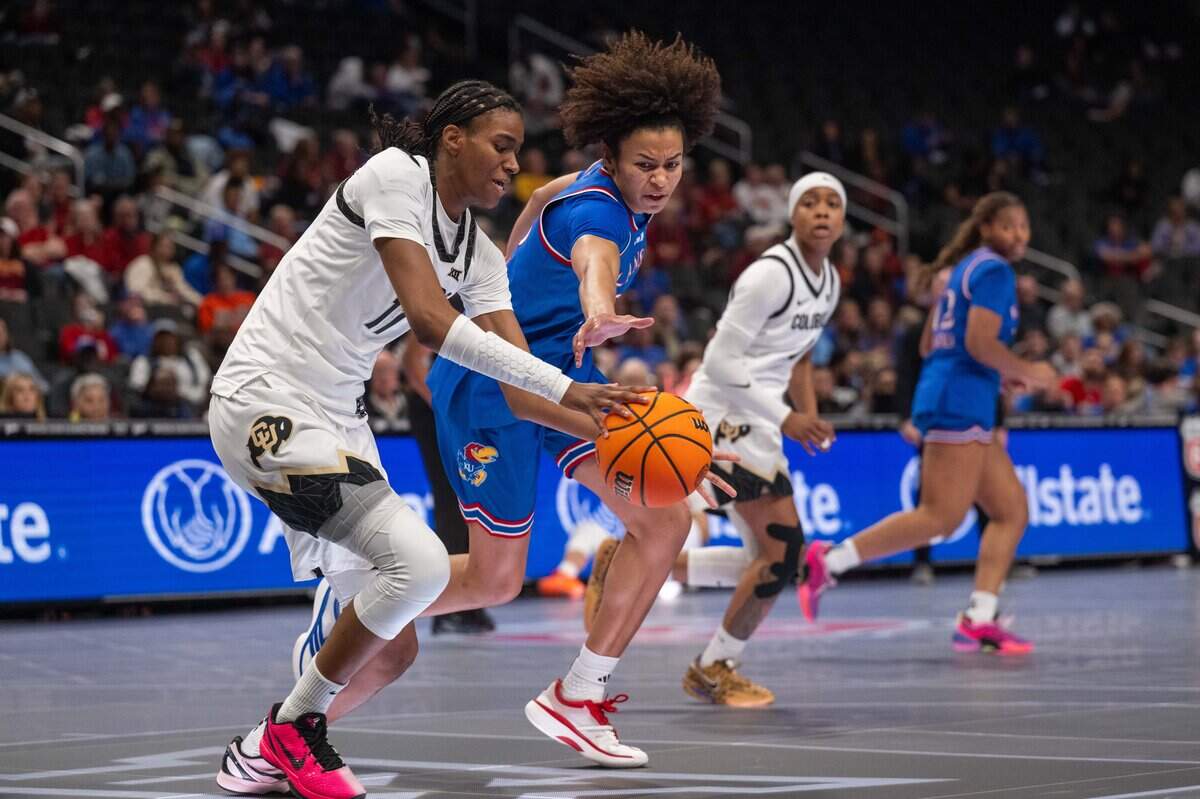 Kansas Jayhawks forward Jaliya Davis (25) fights for a loose ball against Colorado Buffaloes forward Jade Masogayo (14) in the first half of KU’s second-round game at the Big 12 Women's Basketball Tournament on Thursday, March 5, 2026, at T-Mobile Center in Kansas City.