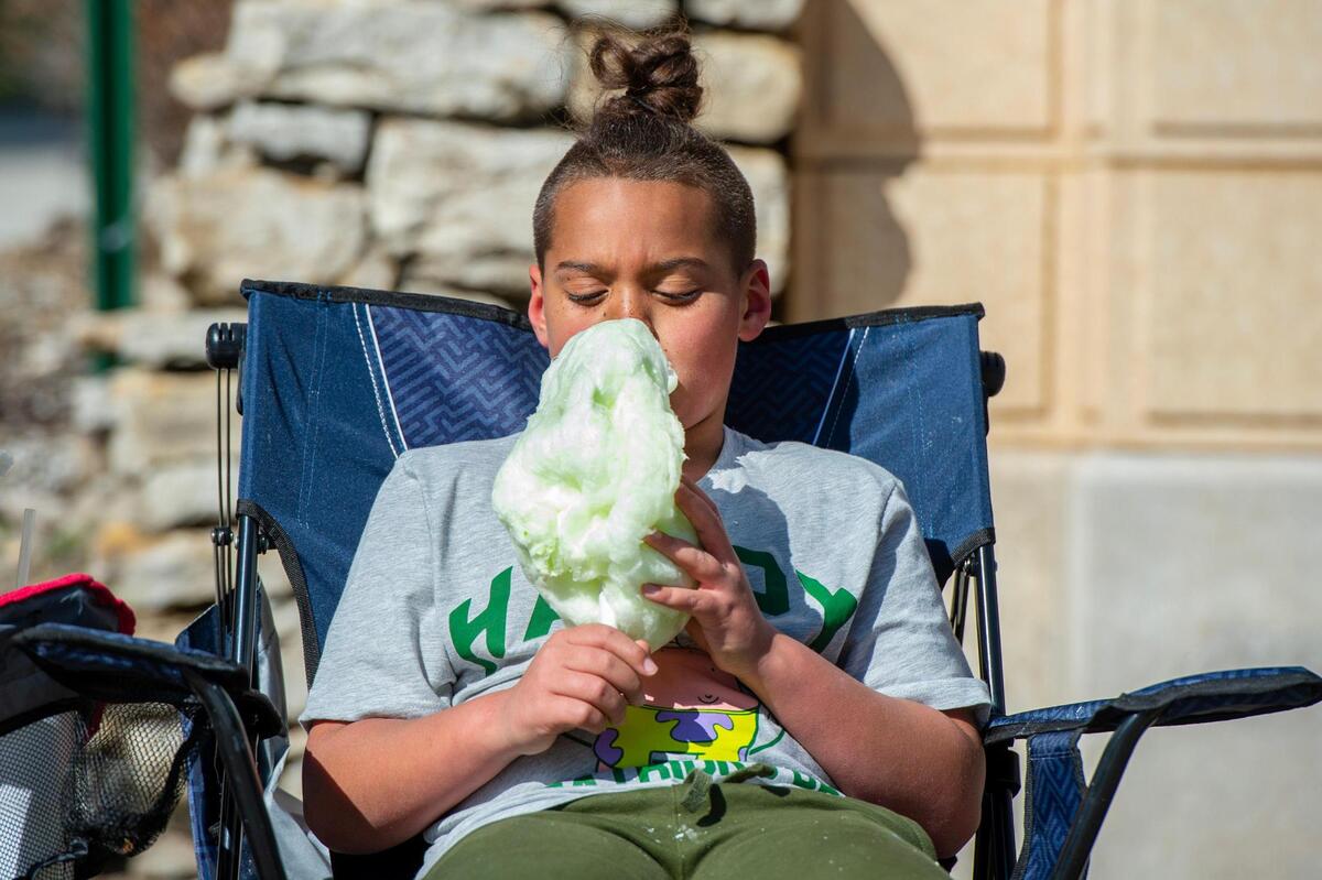 Eight-year-old Monte Jackson enjoys a green cotton candy during the Kansas City St. Patrick’s Day parade on Friday, March 17, 2023, in Kansas City.