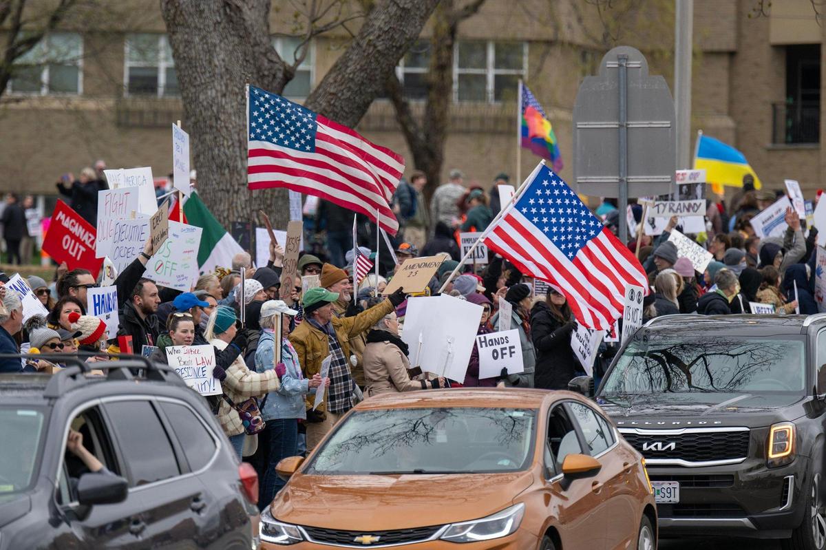 Protesters lined the street and expressed their views during a Hands Off! Kansas City Fights Back, a peaceful pro-democracy rally that takes aim at Elon Musk and Trump administration’s policies on Saturday, April 5, on the Country Club Plaza in Kansas City.