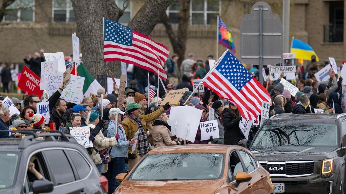 Protesters lined the street near the Country Club Plaza during Hands Off! Kansas City Fights Back, a peaceful pro-democracy rally that took aim at Elon Musk and the Trump administration’s policies on Saturday, April 5, 2025.