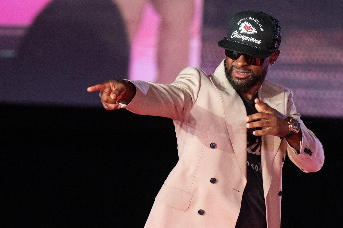 Former Kansas City Chiefs player Dante Hall strikes a pose on the runway Tuesday at the 13th Annual Chiefs Style Lounge at The LEX.
