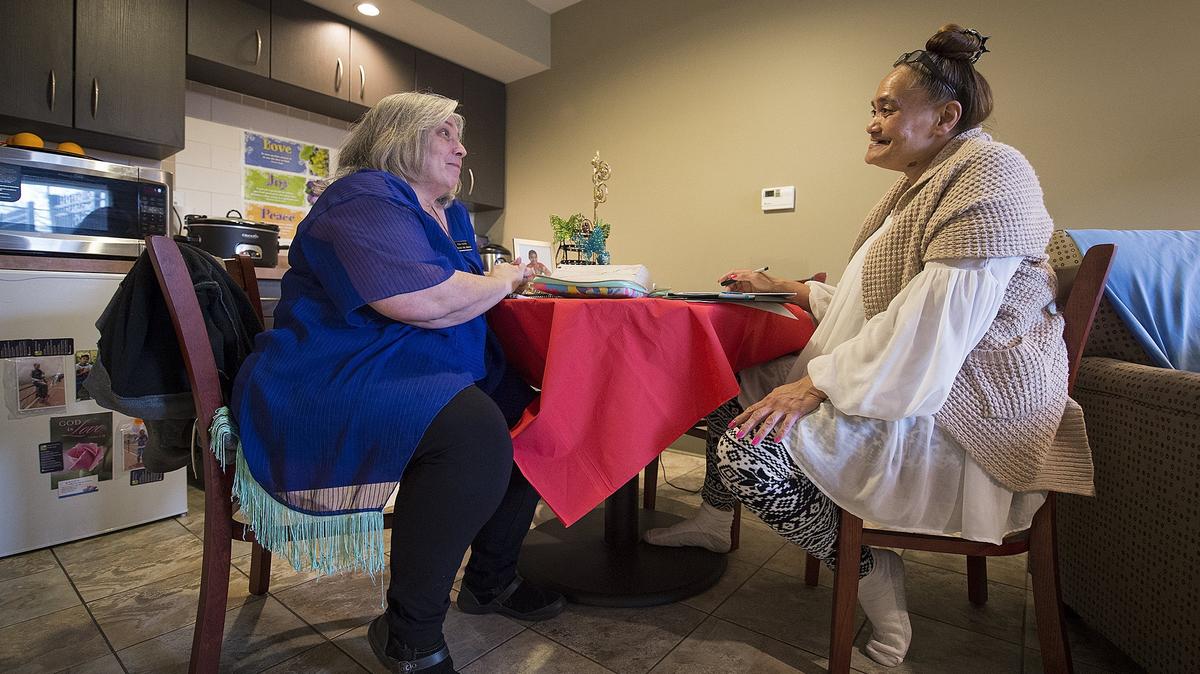 Case manager Mina Foster (left) visits with Amy, a mother who has lived with her son at the Salvation Army's family shelter in Olathe since September. The shelter helped Amy get her life stabilized, and advocates say a similar facility is needed for Johnson County adults who don't have children and are dealing with homelessness. Before moving into the shelter, Amy was living with her son under a bridge in southern Johnson County.