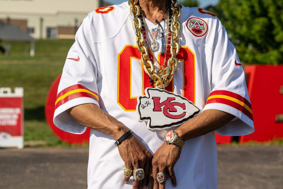 Kansas City Chiefs fan Rodney Clemoens shows off his championship rings and neckless while attending training camp.