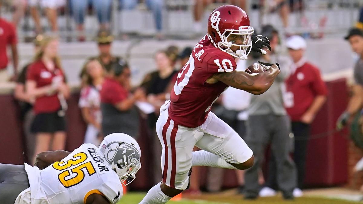 Oklahoma wide receiver Theo Wease (10) avoids a tackle by Kent State defensive back D.J. Miller Jr. (35) during the first half of a game Saturday, Sept. 10, 2022, in Norman, Okla.