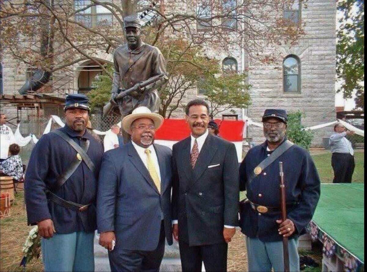 Larry Coleman, seen with Emanuel Cleaver II and Black Civil War re-enactors in front of statue.