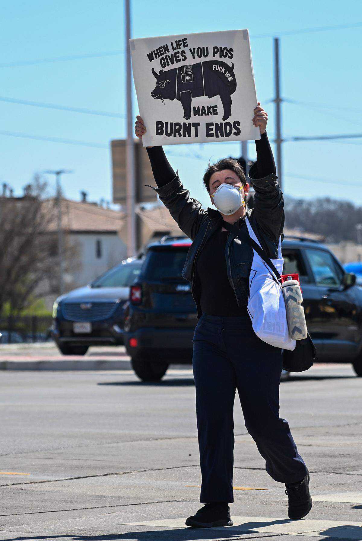 A protester holds up a sign during a No Kings rally against the Trump administration in Mill Creek Park near the Country Club Plaza on Saturday, March 28, 2026, in Kansas City.