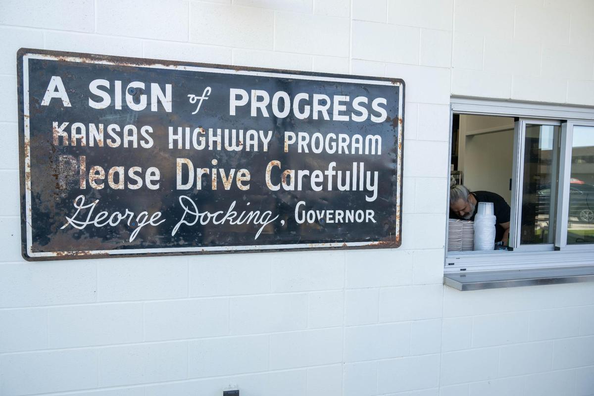 An old sign is posted on the exterior of Hank’s Garage and Grill in Shawnee on Monday, March 10.