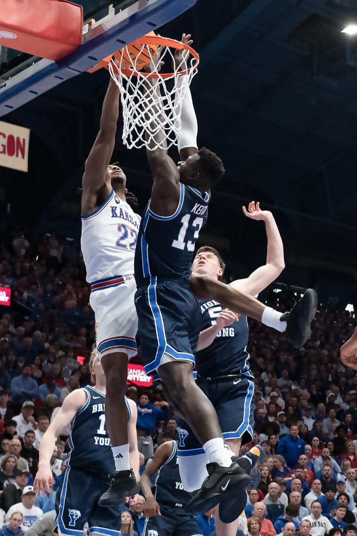 Kansas Jayhawks guard Darryn Peterson (22) throws down a one-handed dunk over BYU Cougars center Keba Keita (13) in the first half at Allen Fieldhouse on Saturday, Jan. 31, 2026, in Lawrence.
