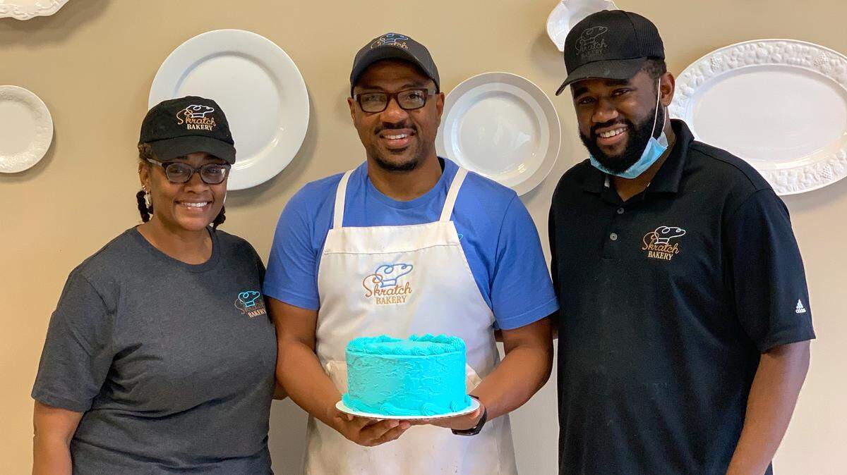 The Kelly family with one of its classic cakes: Kelsey, Ron and Nick