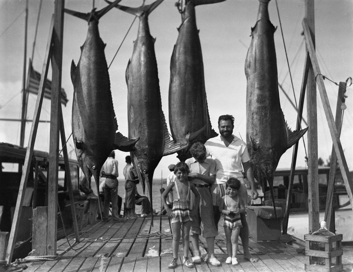 Ernest Hemingway stands with his sons on the docks at Bimini, Bahamas, on July 20, 1935: Patrick Hemingway, from left, John “Bumby” Hemingway and Gregory Hemingway.