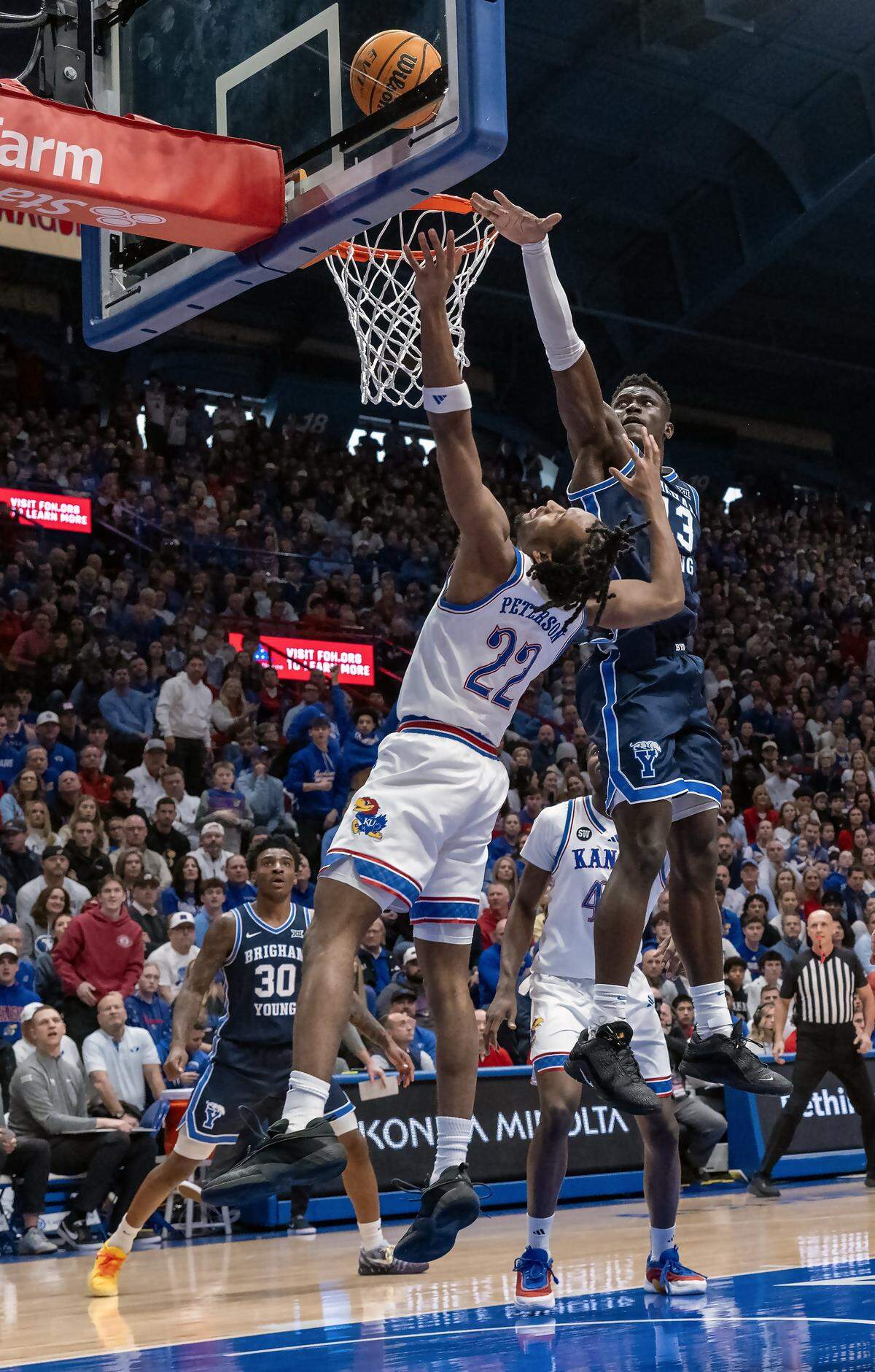 Kansas Jayhawks guard Darryn Peterson (22) goes up for two as BYU Cougars center Keba Keita (13) defends in the first half at Allen Fieldhouse on Saturday, Jan. 31, 2026, in Lawrence.