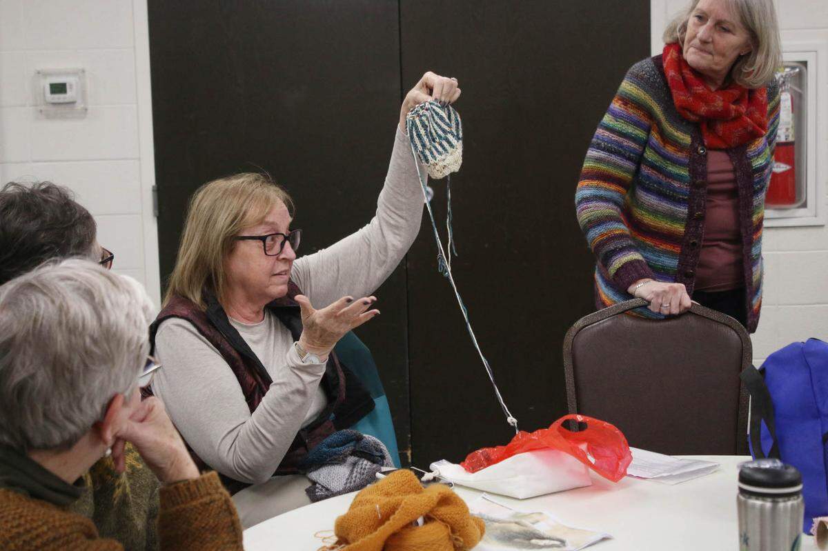 Linda Zappulla of Kansas City shares a project with the group during a meeting of the Sunflower Knitters in Overland Park.