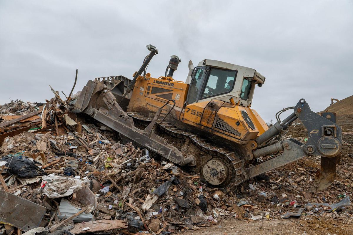 A bulldozer pushes industrial materials in a pile at the Flat Land Excavating landfill on Tuesday, March 23 in Easton, Kansas.