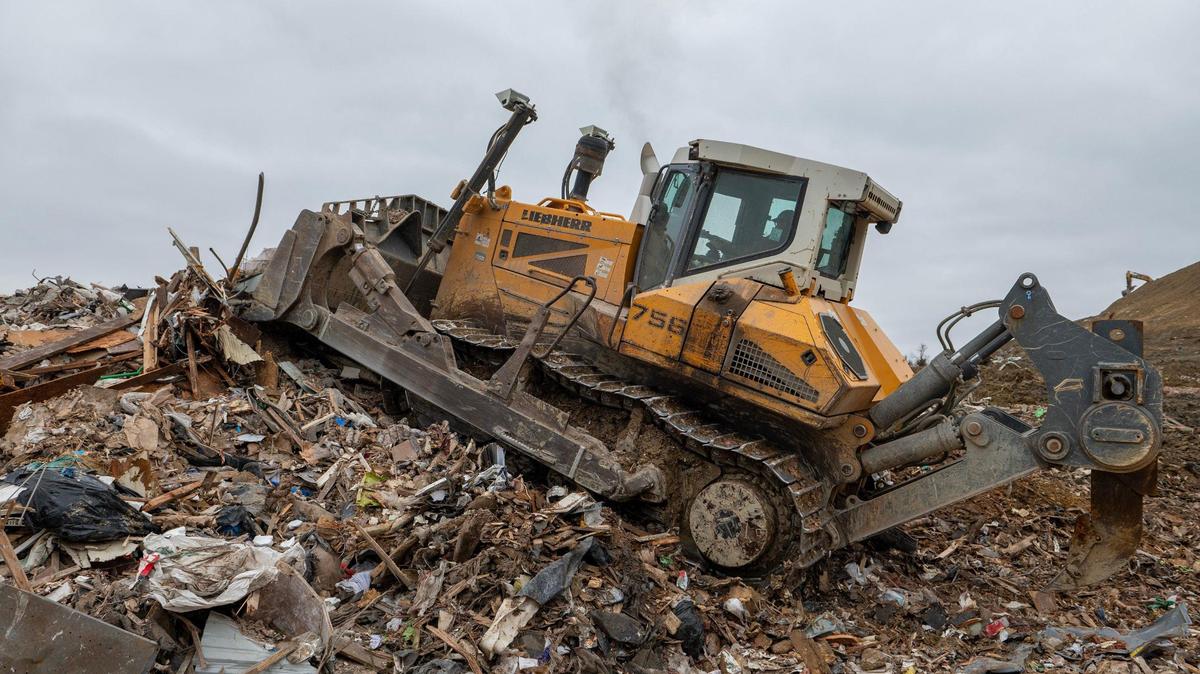 A bulldozer pushes industrial materials in a pile at the Flat Land Excavating landfill near Easton, Kansas.