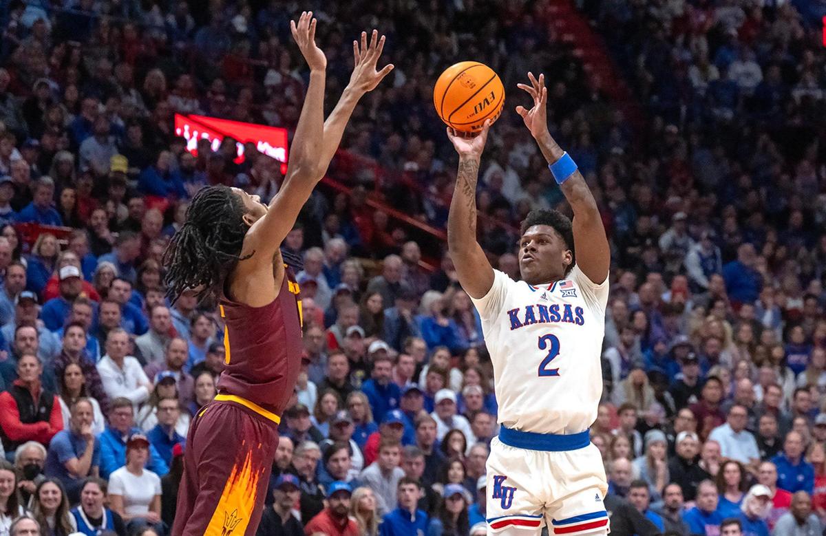 Arizona State Sun Devils guard Amier Ali, left, tries to defend a shot attempt by Kansas Jayhawks guard AJ Storr (No. 2) during a college basketball game at Allen Fieldhouse on Wednesday, Jan. 8, 2025, in Lawrence, Kansas.