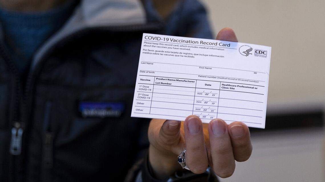 Sarah Gonzalez of New York, a Nurse Practitioner, displays a COVID-19 vaccine card at a New York Health and Hospitals vaccine clinic in the Brooklyn borough of New York Sunday, Jan. 10, 2021. Details from your COVID vaccine card could be used in identify theft, the BBB says. (AP Photo/Craig Ruttle)