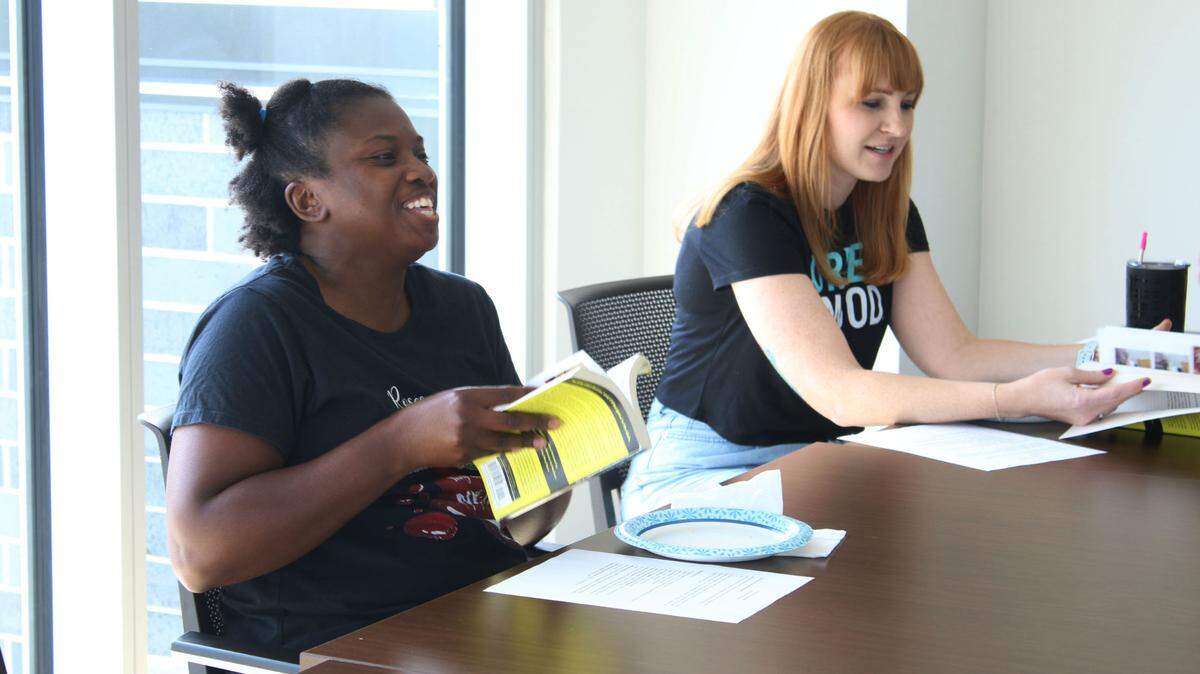 Olathe residents Stephanie Turvey and Heather Davis enjoy a discussion about the Golden State Killer during the July meeting of the Olathe Library’s Crime and Cookies book club.