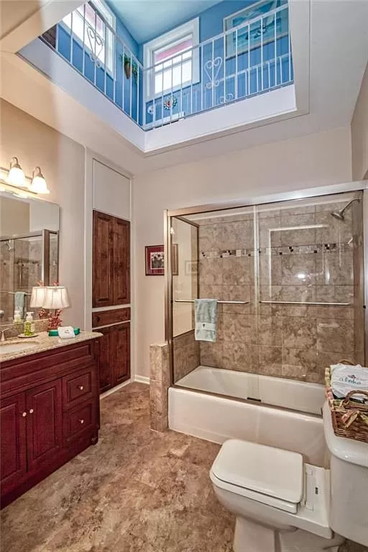 A balcony overlooks the main bathroom at 3232 Windsor Ave. This historic home near the Kansas City Museum in the Northeast includes an indoor pool and a ship’s wheel. Provided by Dylan Van Gerpen. Feb. 9, 2024.