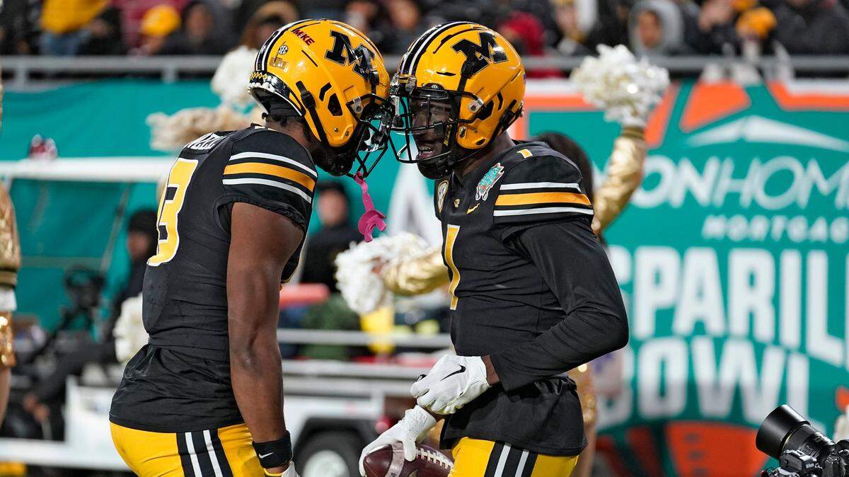 Missouri defensive back Jaylon Carlies, right, celebrates an interception of Wake Forest quarterback Sam Hartman with Tigers teammate Daylan Carnell during the Gasparilla Bowl game in Tampa, Fla.