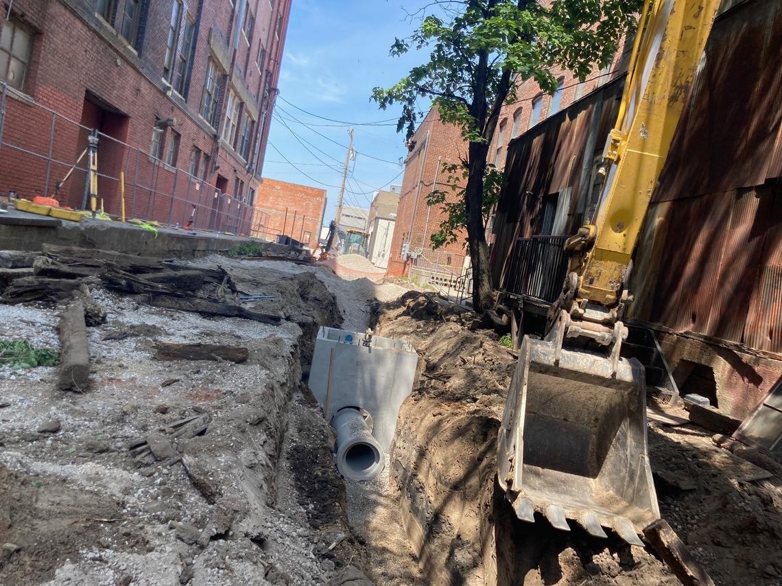 City workers dig a trench to lay sewer lines and other infrastructure in the alley behind The Ship bar and restaurant.