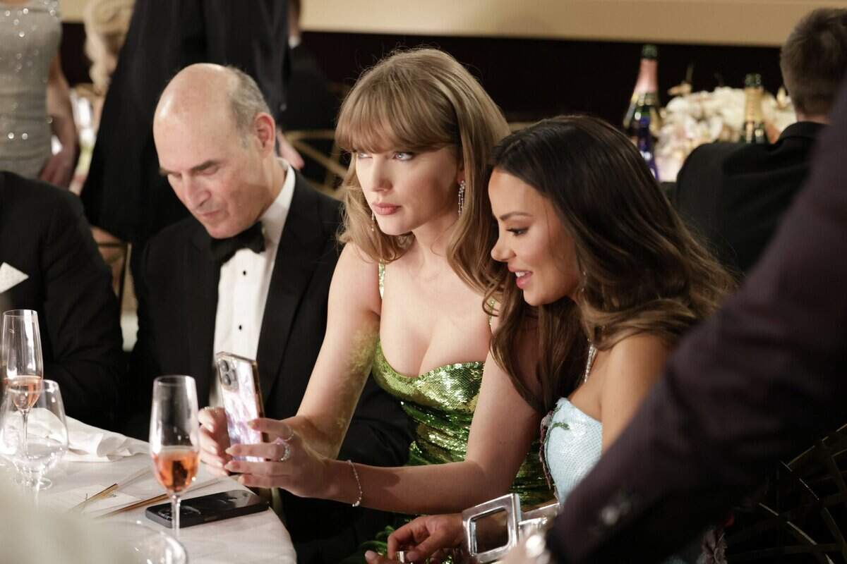 Taylor Swift and friend Keleigh Sperry at the Golden Globes on Sunday, where host and comedian Jo Koy cracked a joke about Swift and her presence at Kansas City Chiefs games. Swift is dating Chiefs tight end Travis Kelce.