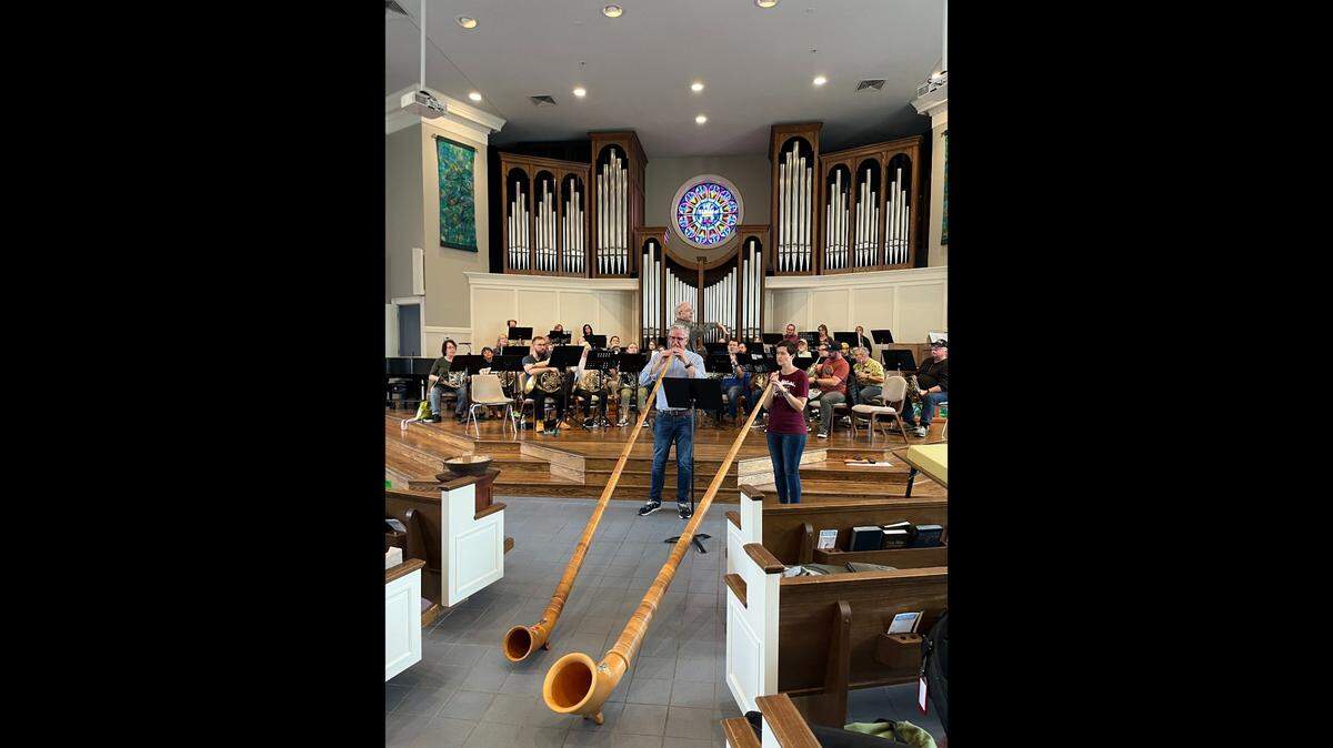 Christian Straif and Tracy Blizman practicing playing alphorns for an upcoming concert of the Kansas City Horn Club.