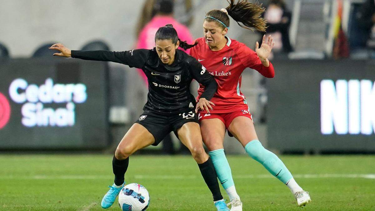 Kansas City Current midfielder Alexis Loera, right, fights Angel City FC forward Christen Press for the ball during a 2022 NWSL match in Los Angeles.
