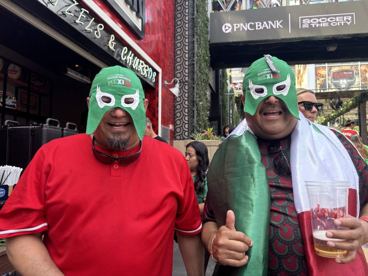 Mario Silva (left) and Jorge Garcia pose in lucha libre masks at the Power and Light District watch party for the opening match of the 2026 FIFA World Cup. Mexico bested South Africa 2-0. June 11, 2026.