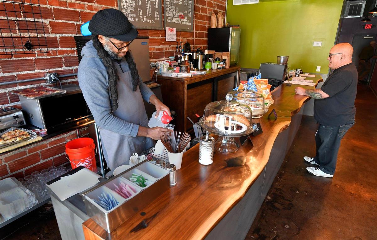 Brad Williams, left, serves a customer at The Borough.